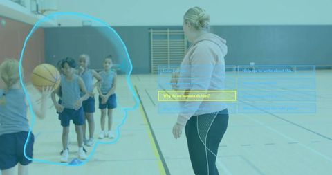 Youth basketball coach guiding kids in gym drill wearing hoodie and leggings