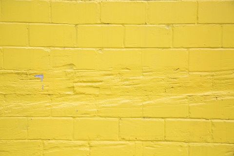 Bright Yellow Brick Wall Closeup in Urban Area