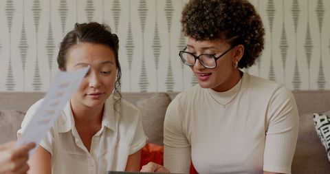 Women collaborating on wedding plans with technology