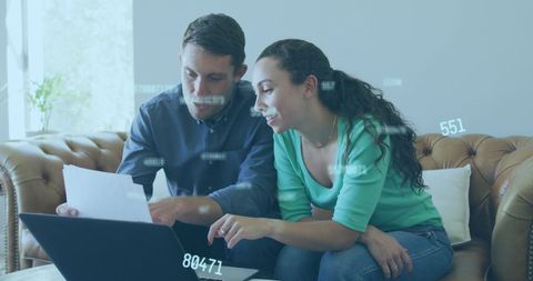 Caucasian Couple Using Laptop Interacting with Digital Data