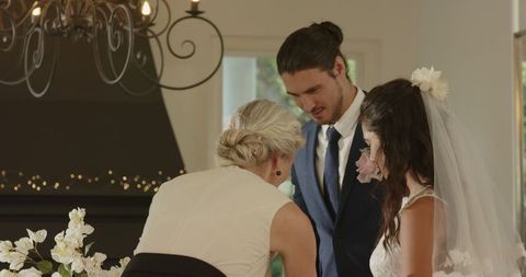 Bride and Groom Smiling Cutting Wedding Cake at Reception
