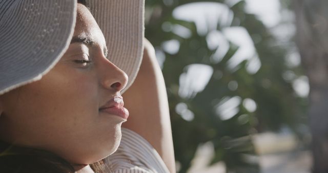 Woman Relaxing in Sunlight with Sun Hat - Download Free Stock Images Pikwizard.com