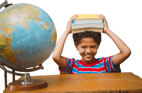 Joyful schoolboy balancing books and transparent globe desk