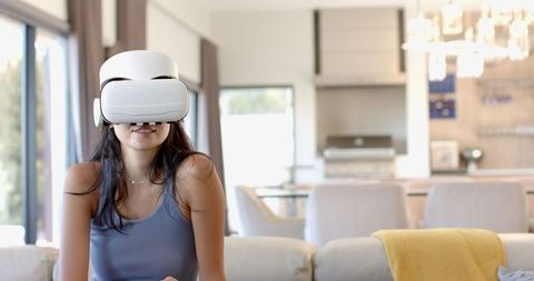 Woman Using VR Headset in Modern Living Room - Download Free Stock Images Pikwizard.com