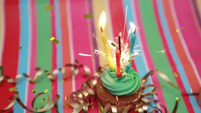 This vibrant scene features a cupcake with lit sparkler and colored candles releasing a festive atmosphere paired with falling confetti against a multi-color background. Suitable for birthday invitations, celebration posters, and festive social media posts, offering an upbeat and joyous theme for any joyful occasion.