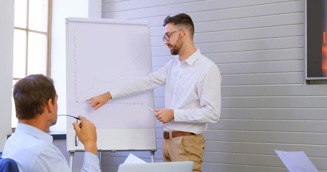 Businessman presenting data analysis with charts during a meeting - Download Free Stock Images Pikwizard.com