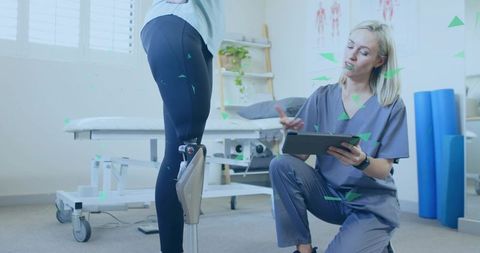 Therapist Assisting Patient with Prosthetic Leg in Rehabilitation Clinic