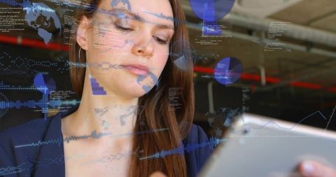 Businesswoman analyzing tablet with holographic analytics and global data overlays