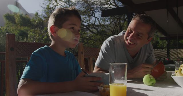 Father and Son Enjoying Breakfast Outdoors on Sunny Morning - Download Free Stock Images Pikwizard.com