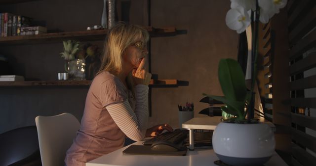 Senior Woman Contemplating and Working on Computer at Home Office Desk - Download Free Stock Images Pikwizard.com