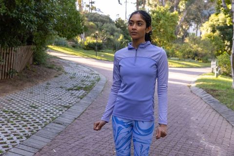 Woman enjoying outdoor activity in park with stylish activewear