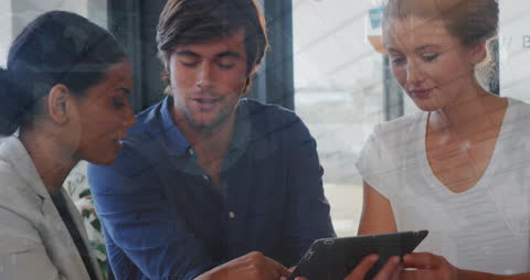 Diverse Colleagues Analyzing Data on Digital Tablet in Modern Office