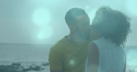 Romantic couple sharing intimate moment on sunlit beach