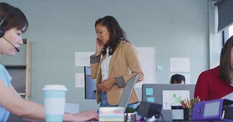 Diverse Business Team Working in Office with Headsets