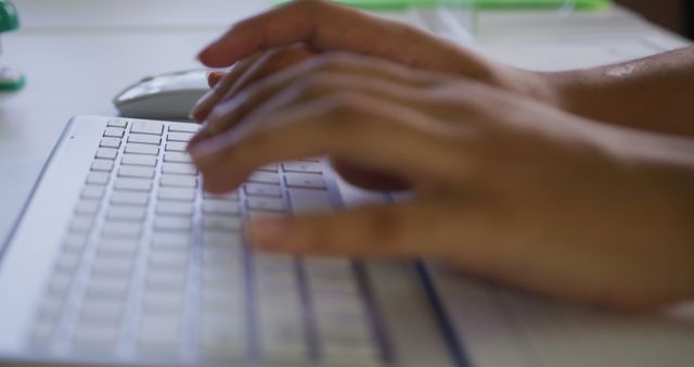 Close up of biracial businesswoman's hands typing on computer keyboard. business person at work in modern office