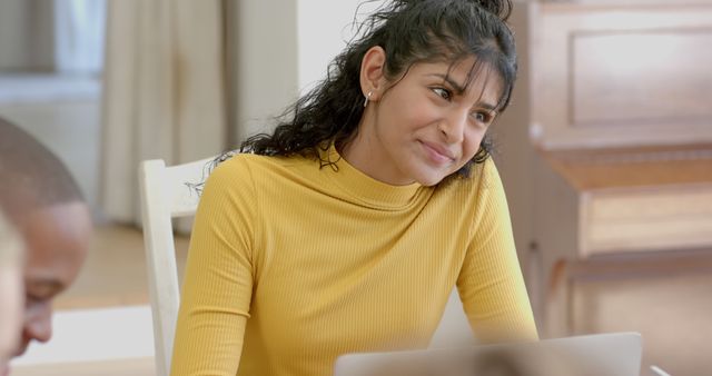 Young Woman Working on Laptop with Thoughtful Expression - Download Free Stock Images Pikwizard.com