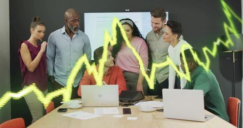 Team Reviewing Report with Digital Analytics Visuals