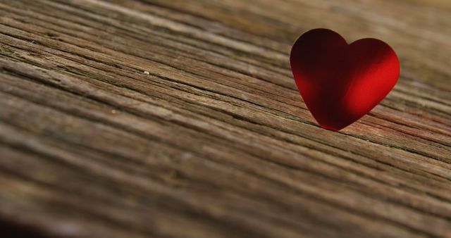 Red heart tuck in the wooden plank. Valentines day concept 4k