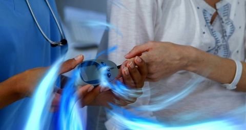 Clinician handing pulse oximeter to patient during vital signs check in outpatient clinic