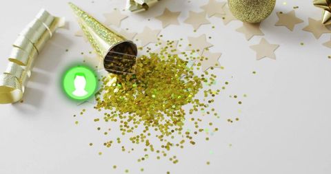 Gold confetti spilling from party cone with glitter stars, ribbon and festive ornament