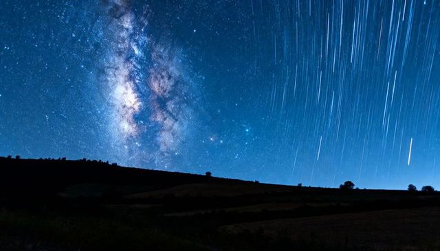Milky Way Core and Meteor Streaks Over Silhouetted Farmland, Long Exposure Night Sky Art
