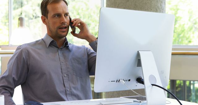 Focused Businessman on Phone in Modern Office - Download Free Stock Images Pikwizard.com