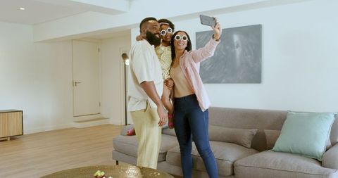 Happy Family Taking Selfie Together in Living Room Celebration