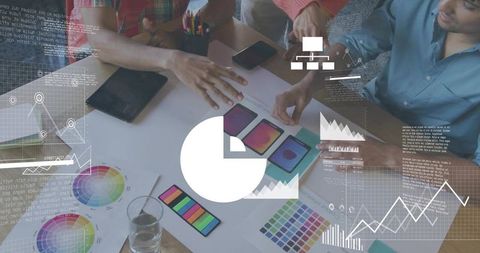 Creative team collaborating on mobile ui mockups with color palettes and data overlays