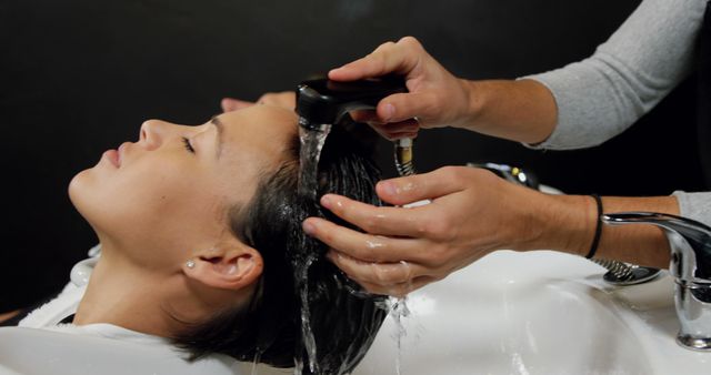 Woman Relaxing While Hair Stylist Washes Hair in Salon - Download Free Stock Images Pikwizard.com