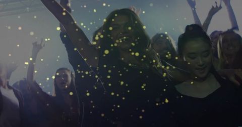 Dancing crowd under golden confetti and club spotlights for nightlife party energy