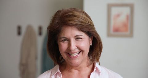 Senior woman smiling in stylish interior home setting