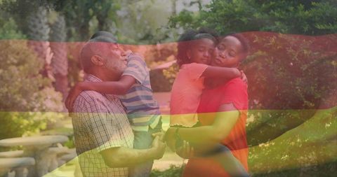 Multigenerational family embracing in park with translucent tricolor overlay symbolizing unity