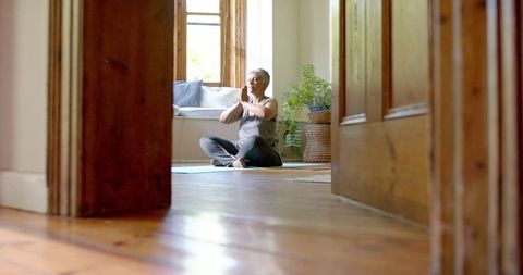 Senior Woman Meditating on Yoga Mat at Home for Mindfulness - Download Free Stock Images Pikwizard.com