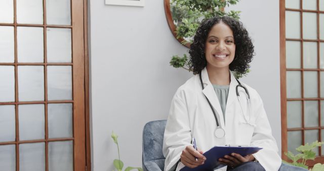 Smiling Female Doctor Wearing Lab Coat and Stethoscope Holding Clipboard - Download Free Stock Images Pikwizard.com