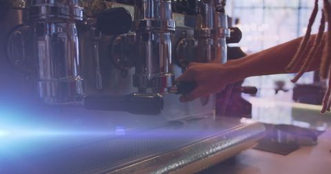 Barista operating espresso machine in cozy café setting