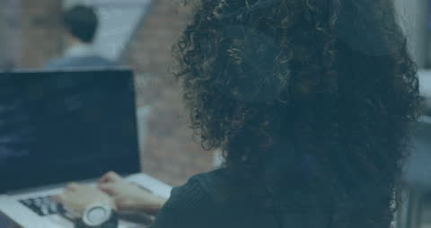Businesswoman Analyzing Data in Modern Office with Laptop