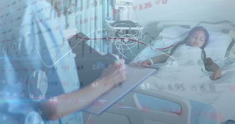 Doctor reviewing data over hospitalized child in hospital room