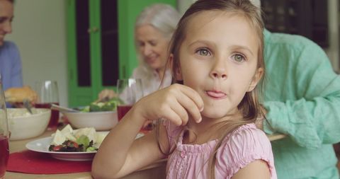 Caucasian Family Dining with Smiling Young Girl Focus