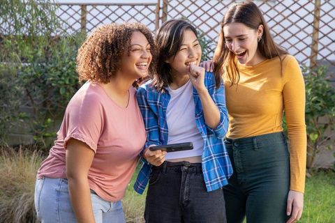 Diverse female friends laughing and enjoying moment together