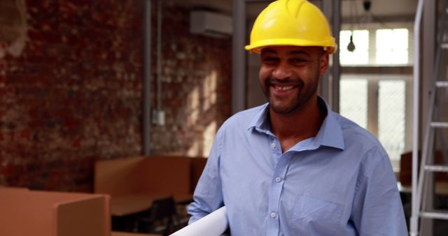 Smiling African American Architect Wearing Hard Hat at Construction Site - Download Free Stock Images Pikwizard.com