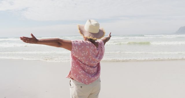 Woman in Pink Shirt Enjoying Freedom at Sunny Beach - Download Free Stock Images Pikwizard.com