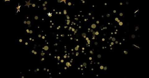 Golden bokeh confetti scattering across black field with glowing stars and glitter streaks