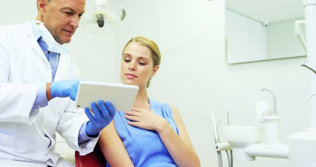 Dentist Showing Digital X-ray to Patient During Consultation in Modern Clinic - Download Free Stock Images Pikwizard.com