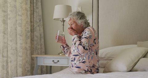 Senior Woman Taking Medication in Peaceful Home Environment