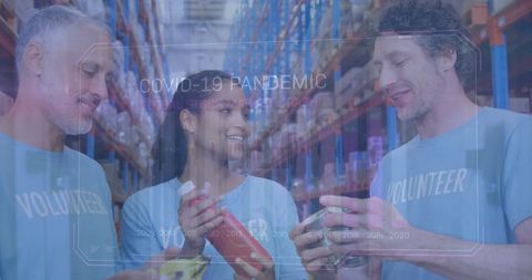 Volunteers in warehouse discuss food distribution amid financial data