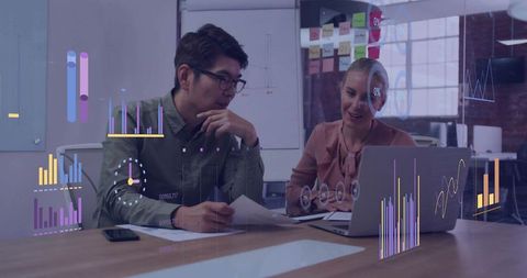 Collaborating professionals analyzing interactive analytics dashboards and charts in modern office