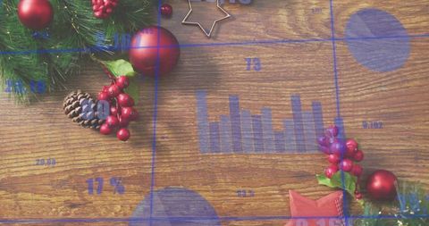 Blue data graphics overlaying rustic holiday wooden tabletop with evergreen sprig and red ornaments