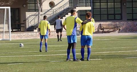 Young Soccer Athletes Training on Field Preparing for Upcoming Match