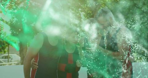 Friends enjoying technology outdoors on sunny patio