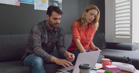 Focused Couple Working Together on Laptop in Home Office - Download Free Stock Images Pikwizard.com